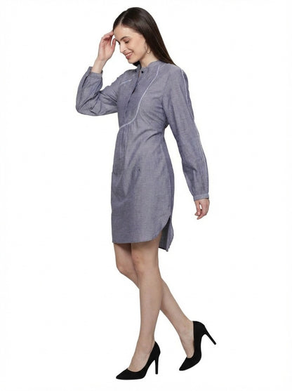 Woman wearing a gray dress with a white background