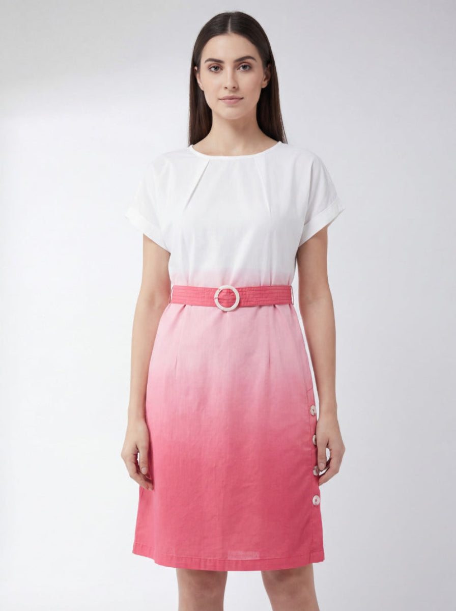 Woman wearing a white top and pink skirt with a belt on a white background